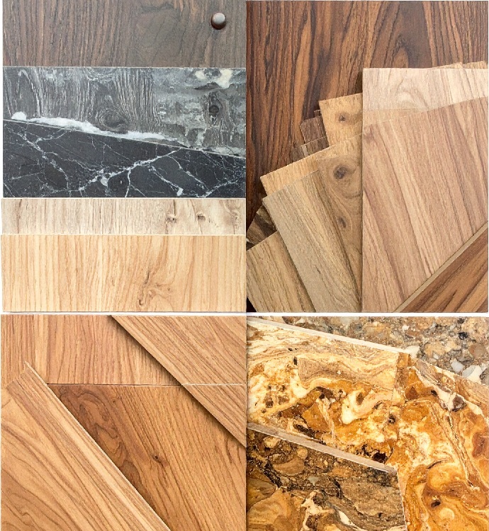 国産と輸入化粧板のサンプルを並べた比較イメージ——木目・石目・無地系のデコールとテクスチャのバリエーション